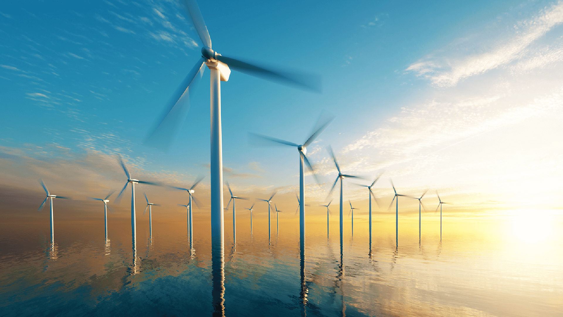Wind turbines silhouetted against a vibrant sunset, harnessing renewable energy from the wind